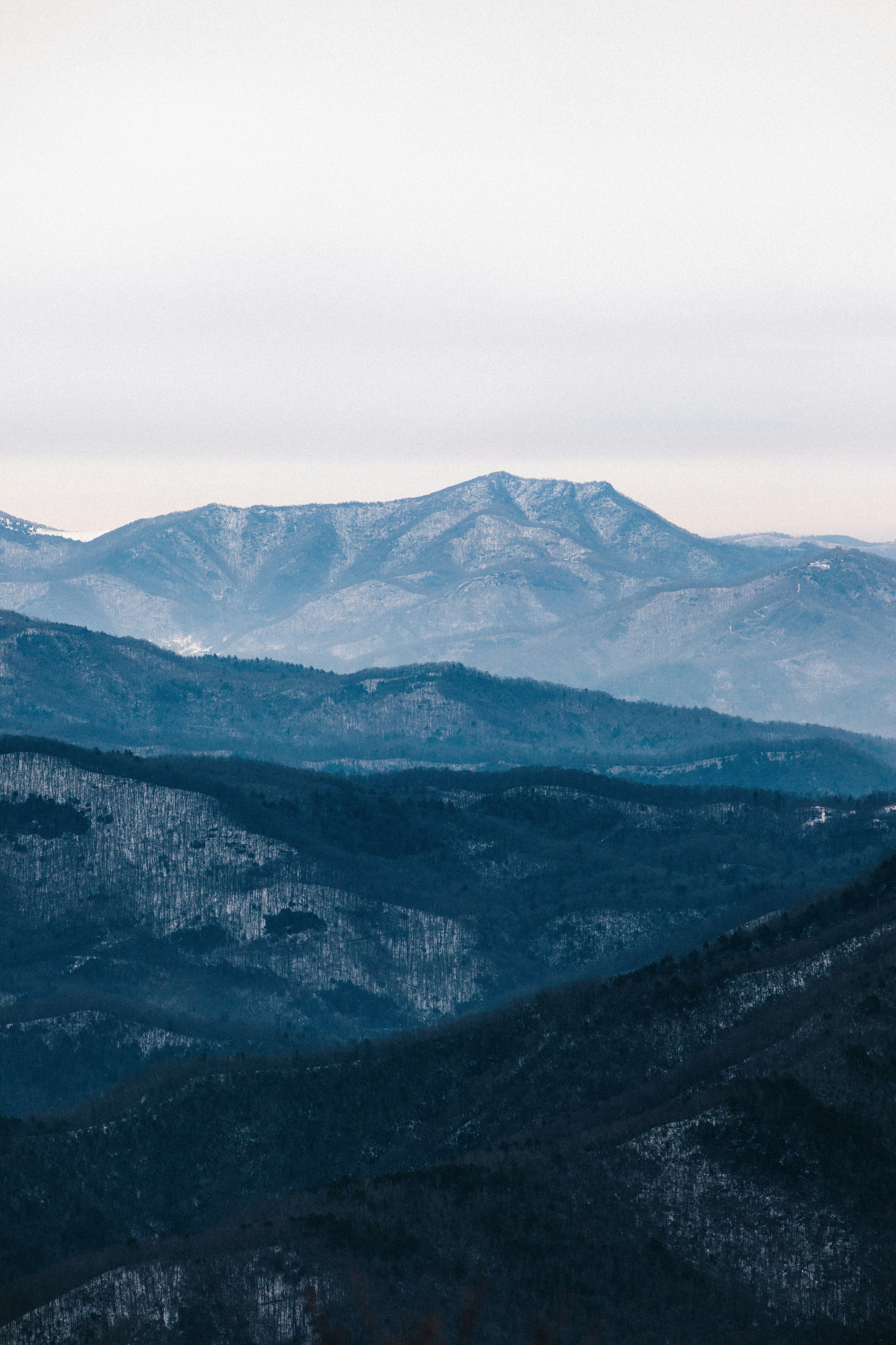 green and black mountains under white sky during daytime